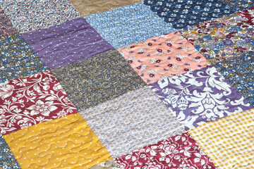 Patchwork print. Quilted quilt with patchwork print. Geometrical pattern. Selective focus