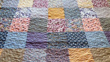 Print in patchwork style. Blanket with print. Geometric pattern on a quilt. Selective focus