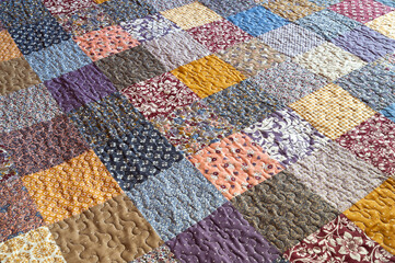 Patchwork print. Blanket with print. Geometric pattern on a quilt. Selective focus