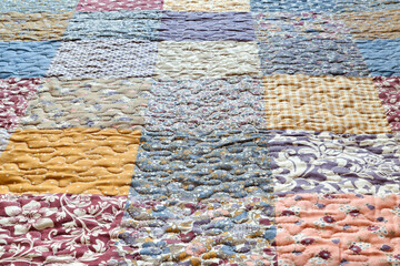 Patchwork print. Blanket with print. Geometric quilt pattern. Selective focus