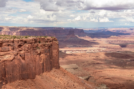 Panoramic aerial view on Colorado River canyon seen from Buck Canyon Overlook near Moab, Island in the Sky District, Canyonlands National Park, San Juan County, Utah, USA. Clouds and sky in summer