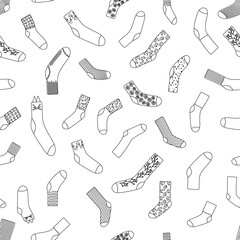Seamless pattern with doodle socks. Wool, cotton warm accessories with modern patterns. Unisex clothes. Black outline isolated on white background. Vector illustration