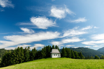 Tiny white hut under blue sky on the green hill in Pieniny mountains