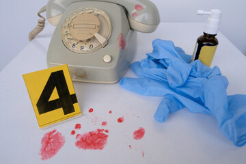 crime scene with evidence markers, idfresh splatter of red blood on retro phone, bloody knife,...