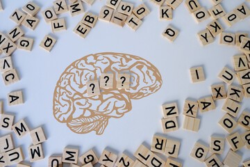 silhouette of brain, word IQ, wooden letters, intelligence quotient on wooden background,...