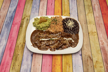 Mexican food menu with chipotle stew, black beans, rice and guacamole with nachos