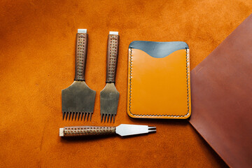 Tools for making leather goods and pieces of brown leather. Production of leather products. View...