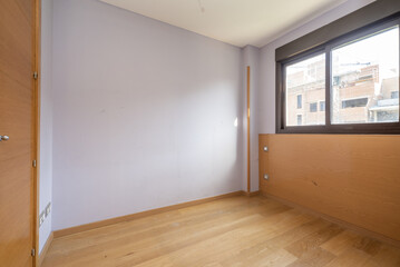 room with brown anodized aluminum windows with glass, violet walls, wooden doors closet and oak hardwood floors