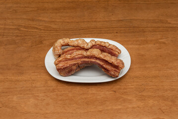 A torrezno is a strip of bacon, always with the skin on, fried or sautéed in a pan or toasted on the grill. the torreznos are crispy and golden on the skin side. They are usually eaten as a tapa