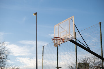 basketball hoop in a neighborhood sports center at sunset