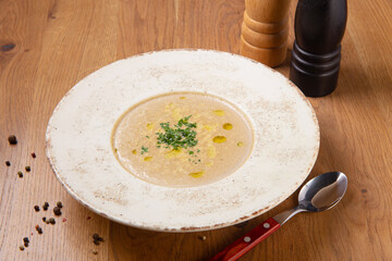 Mushroom cream soup on wooden table.