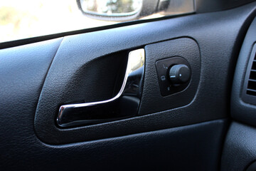 Obraz na płótnie Canvas Car Inside Door Handle Interior. Door trim. Car mirror adjustment.
