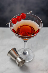 Gin and It cocktail in martini glass garnished with cherries. Martini alcoholic cocktail or non-alcoholic mocktail. Martinis.