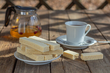 Tea party with sweet Russian waffles on a wooden background. Traditional sweets and dessert.