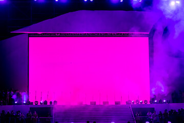 A large stage with a pink screen that says'pink'on it