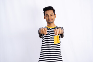 Attractive making Punching hand Gesture to the camera and smiling isolated in a white room