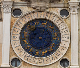 Fototapeta na wymiar Magnificent tower with the astronomical clock. Stars, planets and zodiac. Astronomical clock in Piazza San Marco.