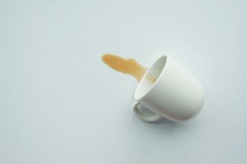 cup of coffee spilled on white 