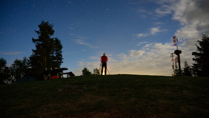 silhouette of people standing on a hill