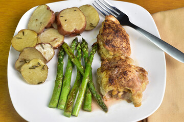 chicken thighs  served with asparagus and potatoes