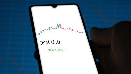Investor analyzing an ETF. Funds stocks exchange ETFs Japanese text: America, buy. アメリカ 証券取引所 投資 shares