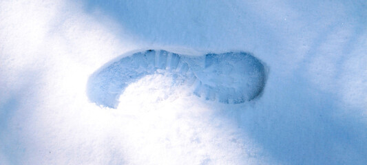 Human boots footprints in snow. Boot print on the snow.