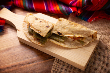 Quesadilla de Comal con queso y Nopales. Typical Mexican quesadilla made on a comal, very popular dish, one of the main street food in Mexico. Table top view