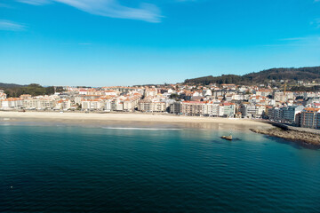 Fototapeta na wymiar Aerial view of beautiful seaside city of Sanxenxo in Galicia, Spain. High quality photo