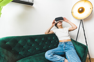  VR concept. Full medium shot. A person having great time playing with a VR headset on her couch. High quality photo