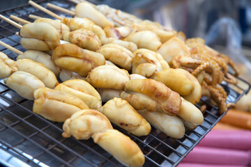 Grilled squid on skewers in the street market of Bangkok