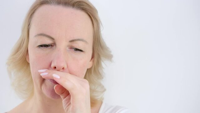 runny nose allergy seasonal attack woman wiping her nose with her hand on white background drugs treatment help unpleasant sensation flowing from the nose cold