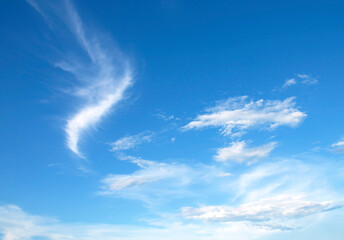 Blue sky and white clouds background, soft focus and horizontal shape copy space.