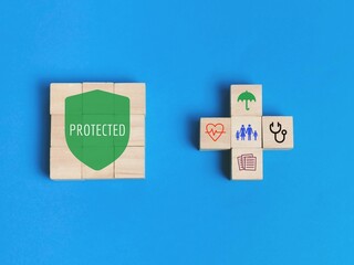 Medical insurance concept with icons on wooden cubes.