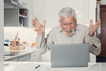 Fototapeta premium Happy excited old elderly man winner excited by reading good news looking at laptop, overjoyed senior mature grandfather watching game online celebrating goal bid bet win great result victory concept.