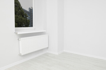 New empty office room with white walls, radiator and clean window. Interior design
