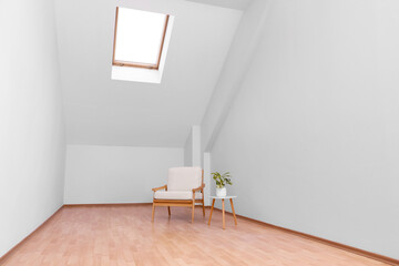 Attic spacious room interior with slanted ceiling and furniture