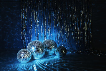 Shiny disco balls indoors, toned in dark blue