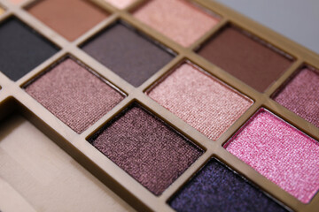 Beautiful eyeshadow palette as background, closeup. Professional cosmetic product