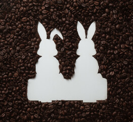 Creative holiday composition made with Easter bunny shape and coffee roasted beans. Flat lay, top...