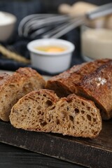 Freshly baked bread on wooden table, closeup