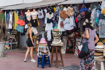 Fototapeta na wymiar unrecognizable people walking in El Chaco boulevard, Ica Peru, looking for souvenirs