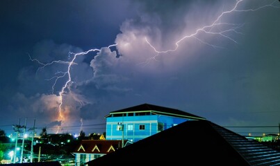 Lightning in the village before the rain in the evening