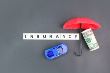 car, umbrella and money with the word insurance. vehicle insurance concept