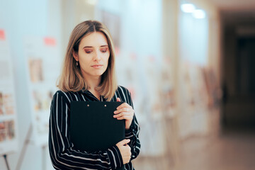 Museum Curator Event Organizer Standing in Exhibit Room. Pensive businesswoman holding a clip...