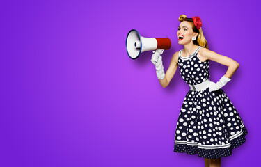 Portrait image of beautiful woman holding mega phone, shout advertising. Pretty girl in black pin up dress, white glows with megaphone loudspeaker. Isolated violet purple background. Big sales ad.