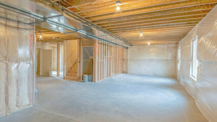 Panorama Large unfinished basement with woodframes and wall insulation