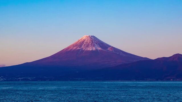 A sunset timelapse of Mt.Fuji near Suruga coast in Shizuoka wide shot zoom