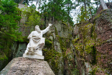 Vainamoinen playing on a kantele - statue of the hero of the epic Kalevala, Park Mon Repos, Vyborg, Russia