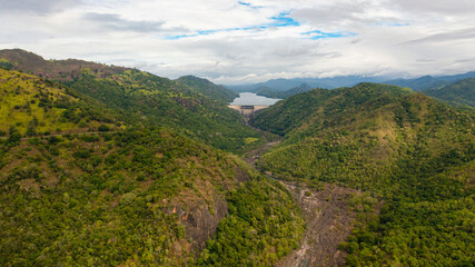 Fototapeta na wymiar Aerial view of Hydroelectric dam in Sri Lanka located in a mountainous area among tropical vegetation.