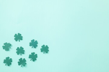 Happy St. Patrick's Day decoration background. Flat lay of cutting paper clover leaves festive...